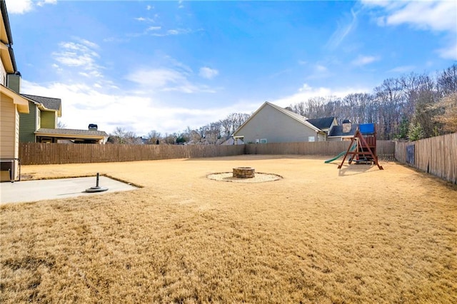 view of yard featuring a fire pit and a playground