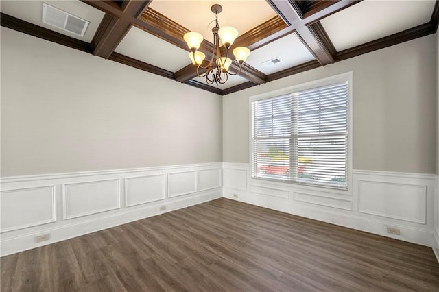 unfurnished room featuring beam ceiling, coffered ceiling, dark wood-type flooring, and an inviting chandelier