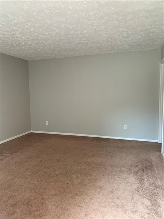 499 Oak Way, Lawrenceville, GA 30046 - empty room featuring carpet flooring and a textured ceiling