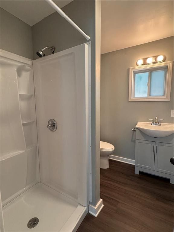 499 Oak Way, Lawrenceville, GA 30046 - full bathroom featuring a stall shower, vanity, and wood finished floors