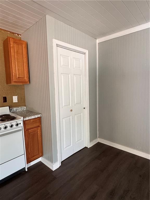 499 Oak Way, Lawrenceville, GA 30046 - kitchen featuring electric range, dark wood-style flooring, brown cabinets, and wooden ceiling