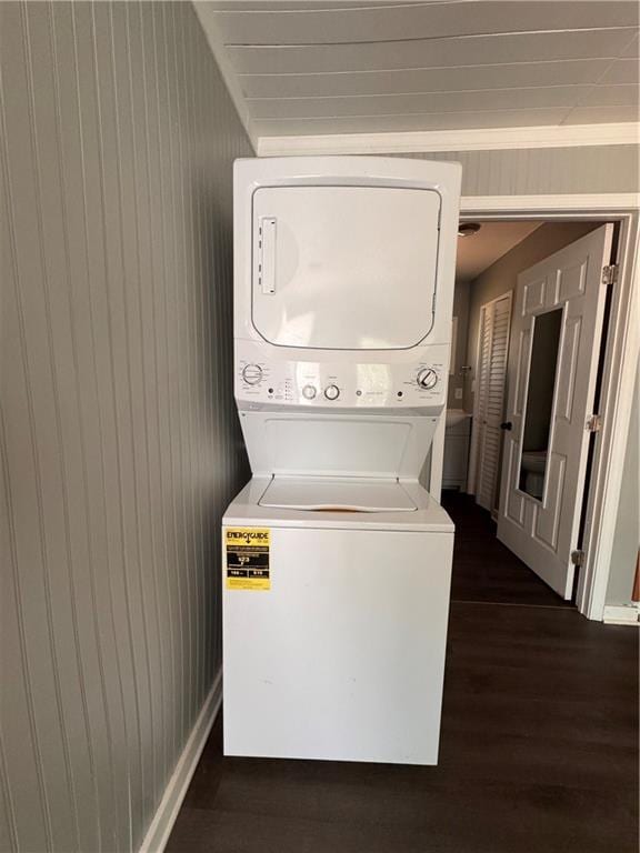 499 Oak Way, Lawrenceville, GA 30046 - laundry room with stacked washing machine and dryer, dark wood-type flooring, and wood walls
