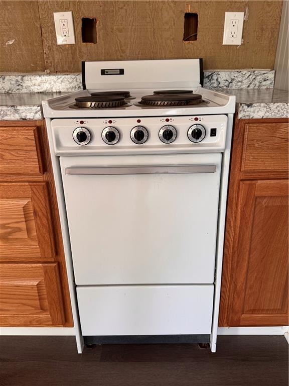 499 Oak Way, Lawrenceville, GA 30046 - kitchen view of white electric range oven, brown cabinets, and wood finished floors