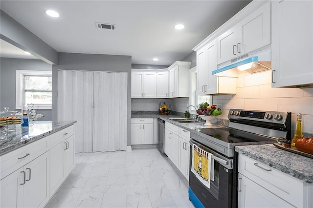 10664 Sandpiper Rd, Jonesboro, GA 30238 - kitchen with stainless steel appliances, under cabinet range hood, a sink, light marble finish flooring, and white cabinets