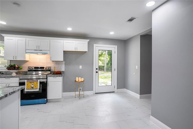 10664 Sandpiper Rd, Jonesboro, GA 30238 - kitchen with stainless steel range with electric cooktop, under cabinet range hood, light marble finish floors, plenty of natural light, and recessed lighting