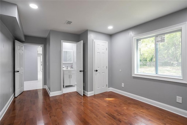 10664 Sandpiper Rd, Jonesboro, GA 30238 - unfurnished bedroom with dark wood finished floors, baseboards, recessed lighting, ensuite bathroom, and a sink