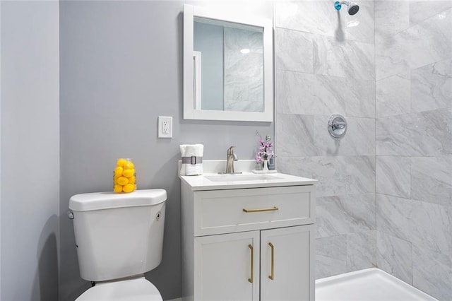 10664 Sandpiper Rd, Jonesboro, GA 30238 - bathroom with toilet, a tile shower, and vanity