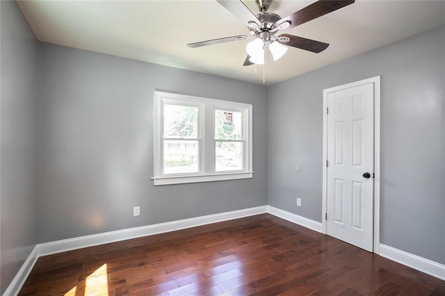 10664 Sandpiper Rd, Jonesboro, GA 30238 - unfurnished room featuring dark wood-style floors, baseboards, and a ceiling fan