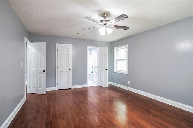 10664 Sandpiper Rd, Jonesboro, GA 30238 - unfurnished bedroom with baseboards, wood finished floors, ensuite bathroom, ceiling fan, and a textured ceiling