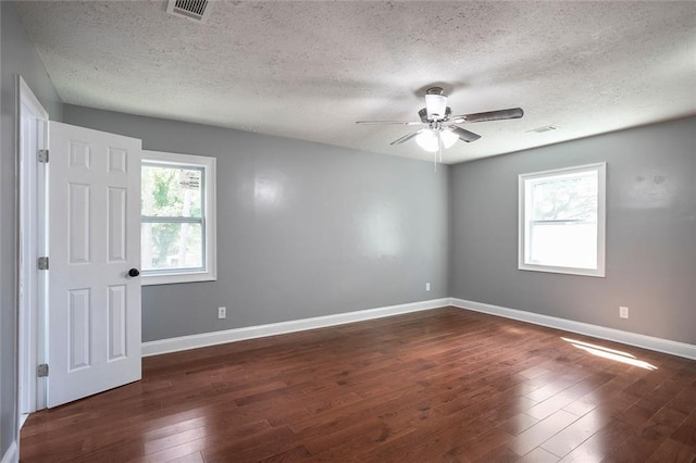 10664 Sandpiper Rd, Jonesboro, GA 30238 - unfurnished room featuring a textured ceiling, ceiling fan, dark wood finished floors, and baseboards