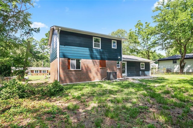 10664 Sandpiper Rd, Jonesboro, GA 30238 - back of house with brick siding, central AC, and a patio area