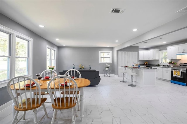 10664 Sandpiper Rd, Jonesboro, GA 30238 - dining room featuring baseboards, recessed lighting, and light marble finish flooring