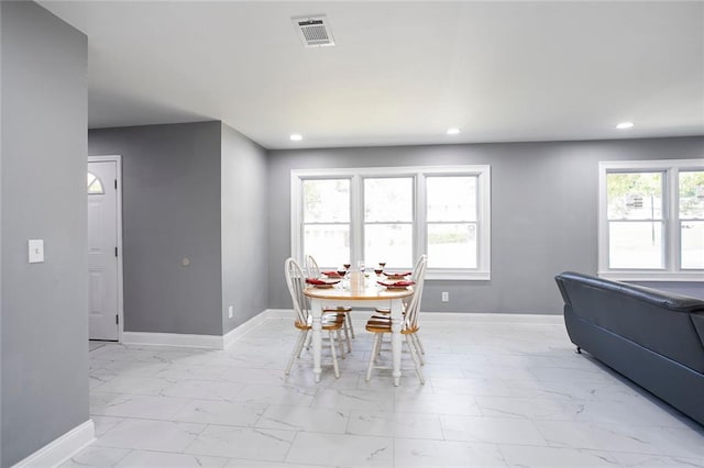 10664 Sandpiper Rd, Jonesboro, GA 30238 - dining space featuring light marble finish flooring, baseboards, and recessed lighting