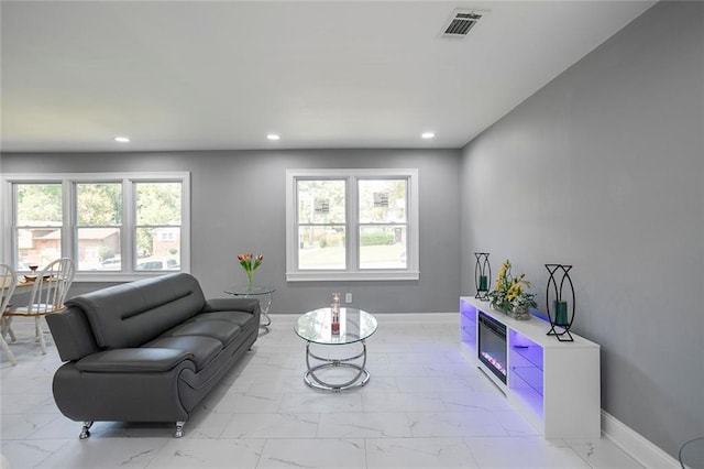 10664 Sandpiper Rd, Jonesboro, GA 30238 - living area with light marble finish flooring, recessed lighting, healthy amount of natural light, and baseboards