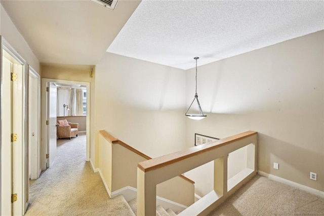 145 15th St NE Unit 204, Atlanta, GA 30309 - corridor with light carpet, baseboards, and an upstairs landing
