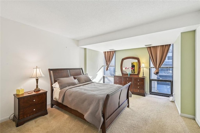 145 15th St NE Unit 204, Atlanta, GA 30309 - bedroom with light colored carpet, visible vents, and baseboards