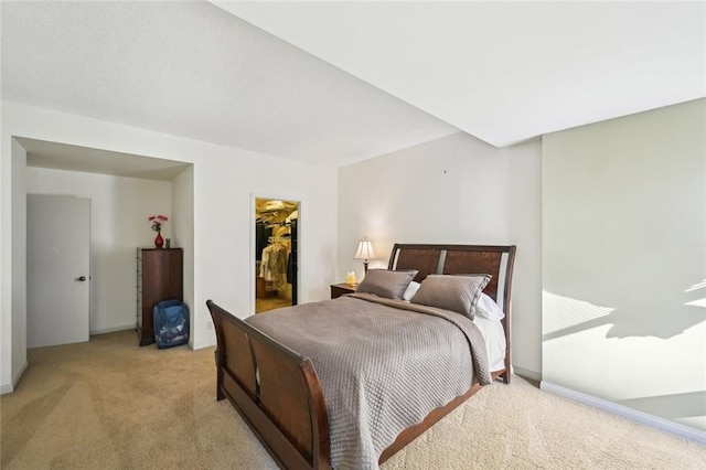 145 15th St NE Unit 204, Atlanta, GA 30309 - bedroom with light carpet, a spacious closet, and a closet