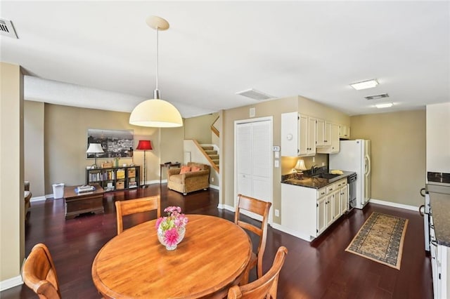 145 15th St NE Unit 204, Atlanta, GA 30309 - dining area with baseboards, dark wood-style flooring, stairway, and visible vents