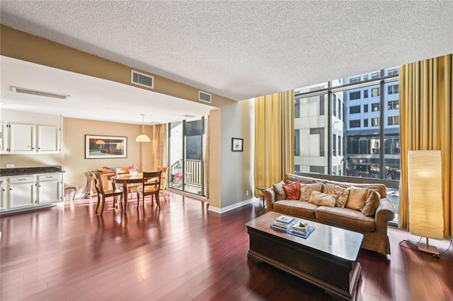 145 15th St NE Unit 204, Atlanta, GA 30309 - living area with dark wood finished floors, visible vents, and a textured ceiling