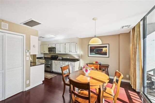 145 15th St NE Unit 204, Atlanta, GA 30309 - dining area featuring baseboards, visible vents, and dark wood-style floors