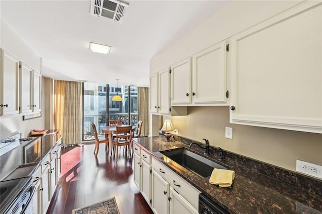 145 15th St NE Unit 204, Atlanta, GA 30309 - kitchen featuring stainless steel electric range oven, visible vents, a sink, white cabinets, and dark wood-style floors