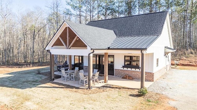 modern inspired farmhouse featuring a patio area