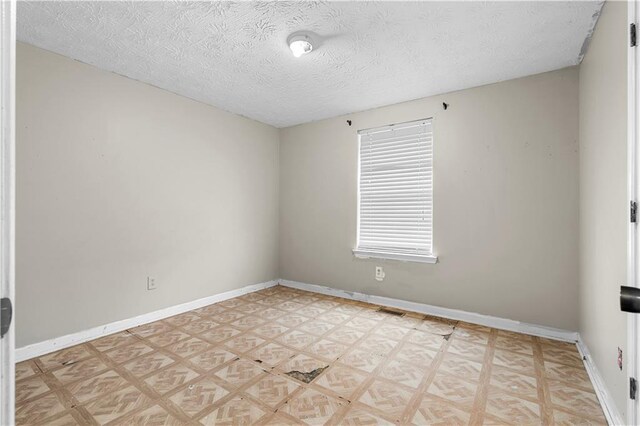 1822 Oriole Trl, Lithia Springs, GA 30122 - unfurnished room featuring baseboards, a textured ceiling, and light floors