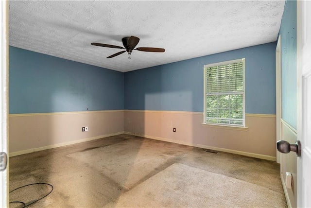 1822 Oriole Trl, Lithia Springs, GA 30122 - spare room featuring a ceiling fan, carpet flooring, a textured ceiling, and baseboards