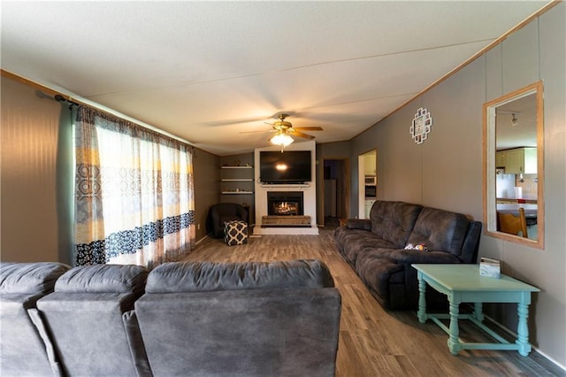 518 W Nance Springs Rd, Resaca, GA 30735 - living area with wood finished floors, a ceiling fan, and a lit fireplace