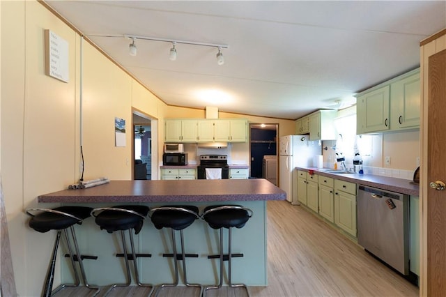 518 W Nance Springs Rd, Resaca, GA 30735 - kitchen with dishwasher, range with electric cooktop, black microwave, a peninsula, and freestanding refrigerator