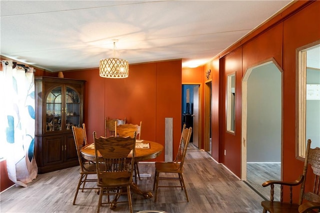 518 W Nance Springs Rd, Resaca, GA 30735 - dining area featuring arched walkways, light wood finished floors, a chandelier, and crown molding