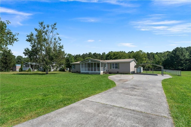 518 W Nance Springs Rd, Resaca, GA 30735 - manufactured / mobile home featuring concrete driveway, a sunroom, a front lawn, and a carport