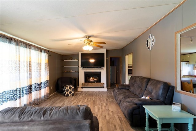 518 W Nance Springs Rd, Resaca, GA 30735 - living area with ceiling fan, wood finished floors, and a warm lit fireplace