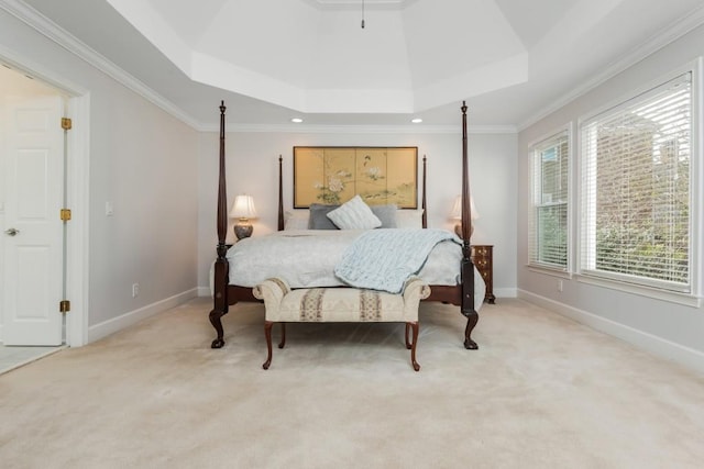 bedroom with ornamental molding, a raised ceiling, carpet flooring, and baseboards