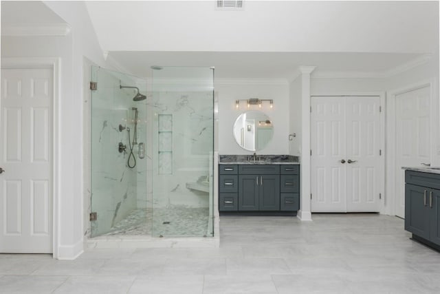 bathroom featuring a marble finish shower, visible vents, crown molding, and vanity