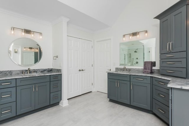 full bathroom featuring two vanities, a sink, vaulted ceiling, a stall shower, and crown molding