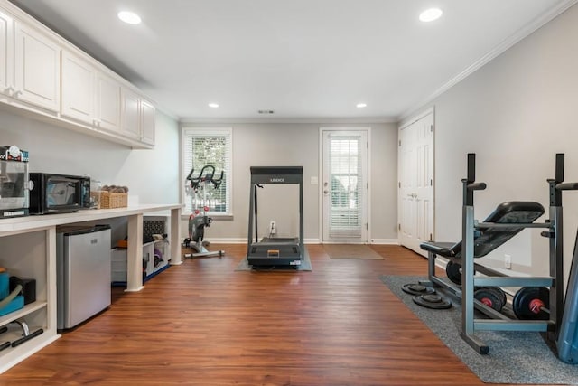 workout area featuring baseboards, ornamental molding, dark wood-style flooring, and recessed lighting