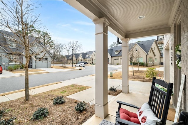 view of patio / terrace with a residential view and covered porch