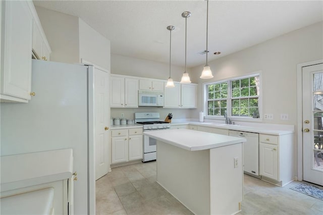 4321 Sugar Maple Chase NW, Acworth, GA 30101 - kitchen featuring white appliances, white cabinets, a kitchen island, light countertops, and hanging light fixtures