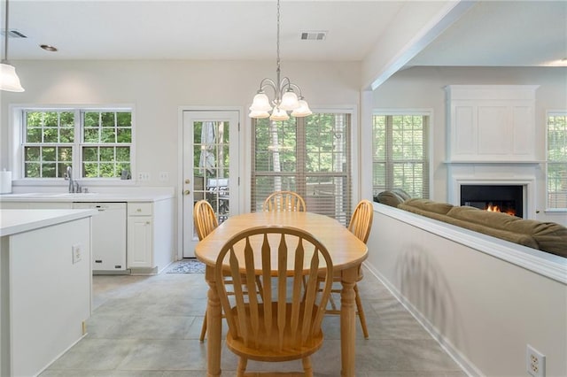 4321 Sugar Maple Chase NW, Acworth, GA 30101 - dining space featuring healthy amount of natural light, a chandelier, and a warm lit fireplace