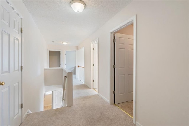 4321 Sugar Maple Chase NW, Acworth, GA 30101 - hallway with an upstairs landing, light carpet, baseboards, and a textured ceiling