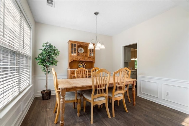 4321 Sugar Maple Chase NW, Acworth, GA 30101 - dining area featuring a chandelier, dark wood-type flooring, a decorative wall, and a wainscoted wall