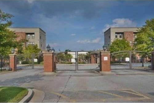 exterior space with a gate, a gated entry, and curbs