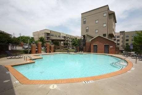 community pool featuring a patio area and fence