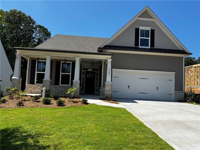 craftsman house featuring a porch and a front yard