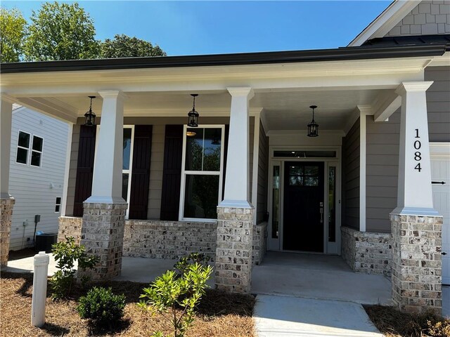 doorway to property with central AC and a porch