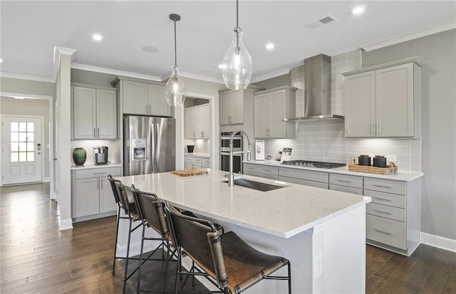 kitchen featuring visible vents, appliances with stainless steel finishes, wall chimney exhaust hood, and gray cabinetry