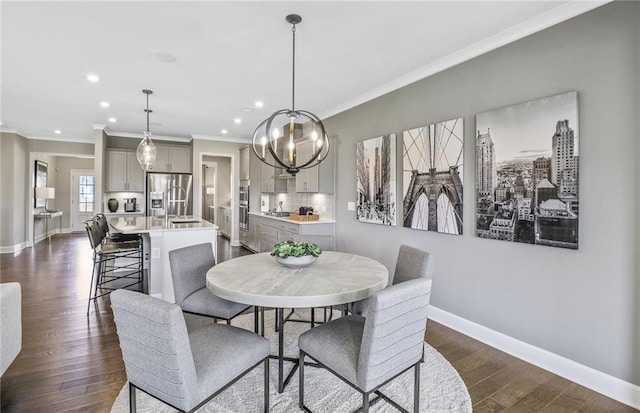 dining space with baseboards, ornamental molding, recessed lighting, a notable chandelier, and dark wood-style flooring