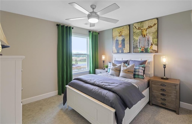 bedroom with visible vents, baseboards, light colored carpet, and a ceiling fan