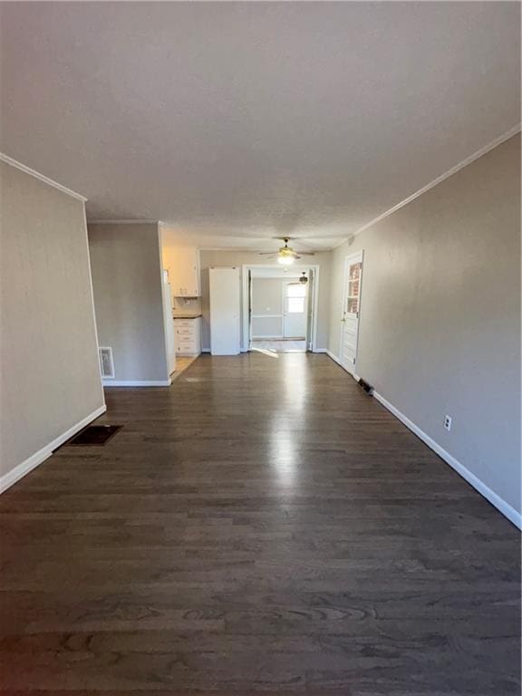 unfurnished room featuring crown molding, ceiling fan, and dark wood-type flooring